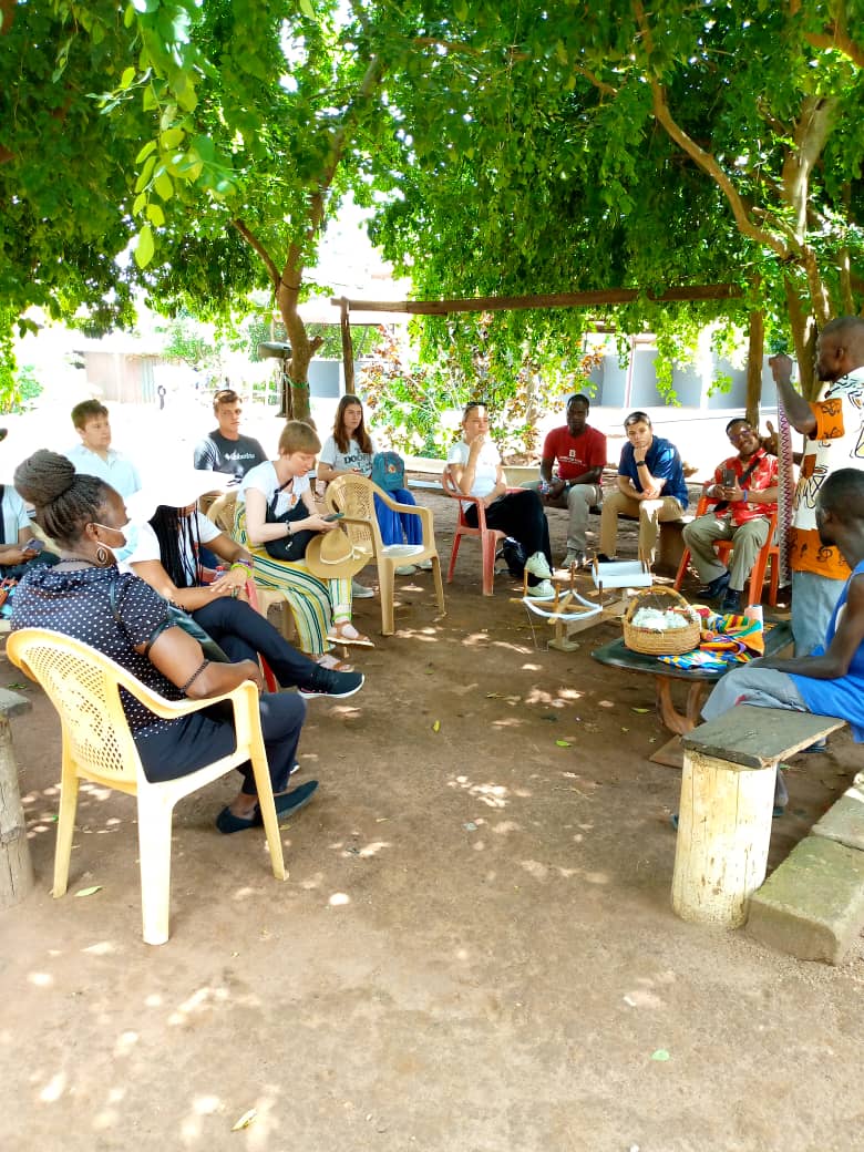 Faculty and staff learning from a Ghanaian citizen. 