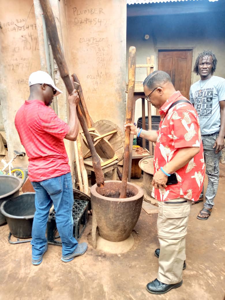 Faculty examining a Ghanaian tool. 